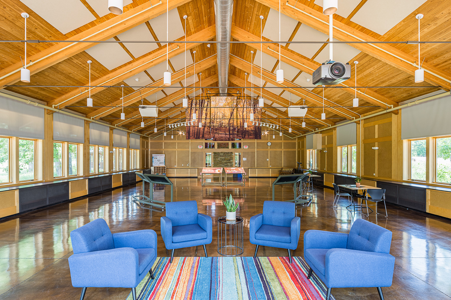 Cylinder pendant downlights provide general lighting in the Four Rivers Environmental Education Center event hall.