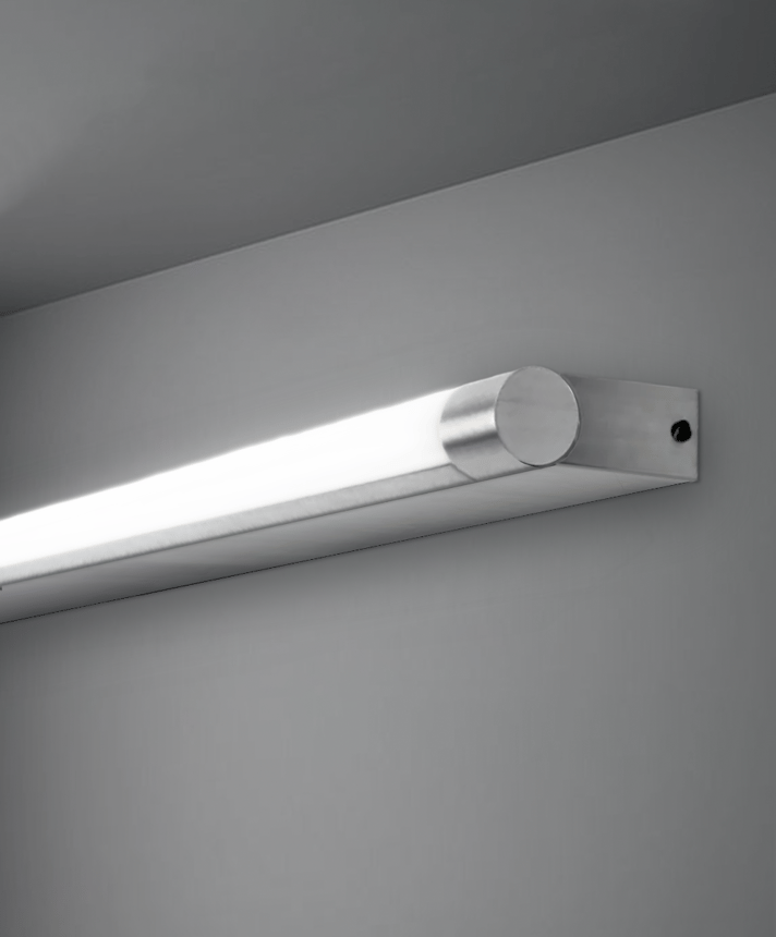 11702 rotatable dressing room vanity light shown in silver finish and with a rotating cylindrical lens.