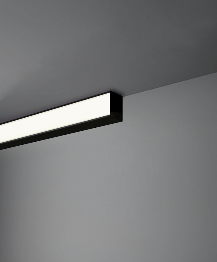 Alcon 12100-6 surface linear ceiling light shown in black finish and with a flush trim-less lens.