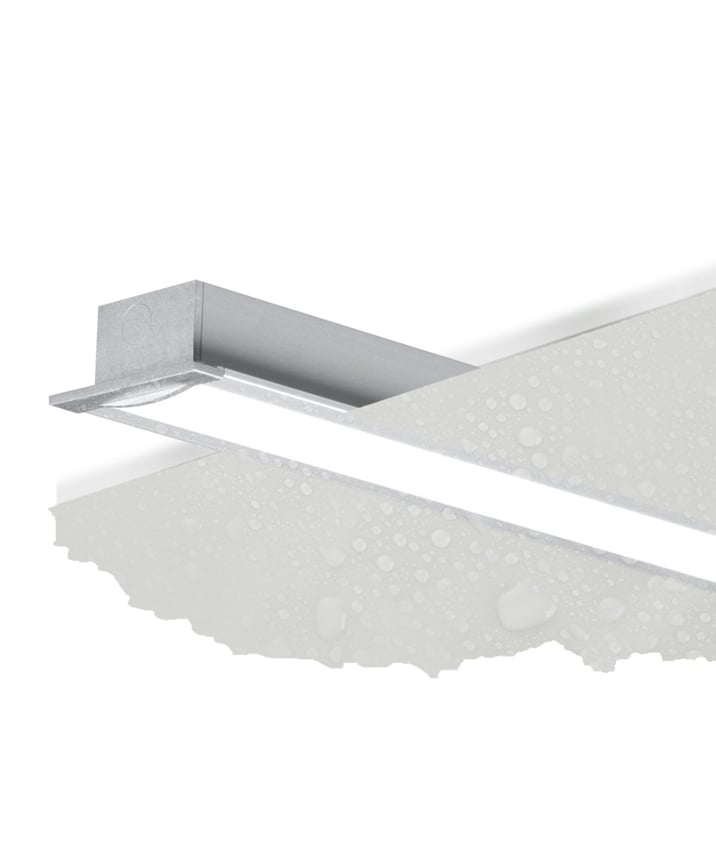 The 12100-24-R wet-location recessed linear LED light shown with a silver finish and a flush lens in a wood ceiling