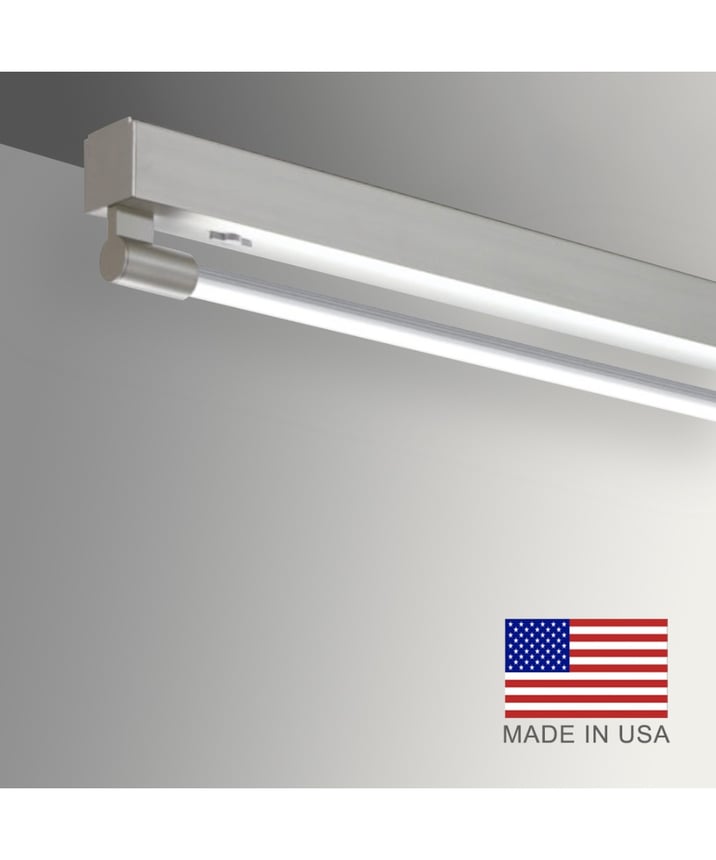 Alcon 12160-S, surface linear ceiling light shown in silver finish and with a tubular half-lit trim-less lens.