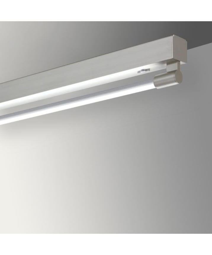Alcon 12160-S, surface linear ceiling light shown in silver finish and with a tubular half-lit trim-less lens.