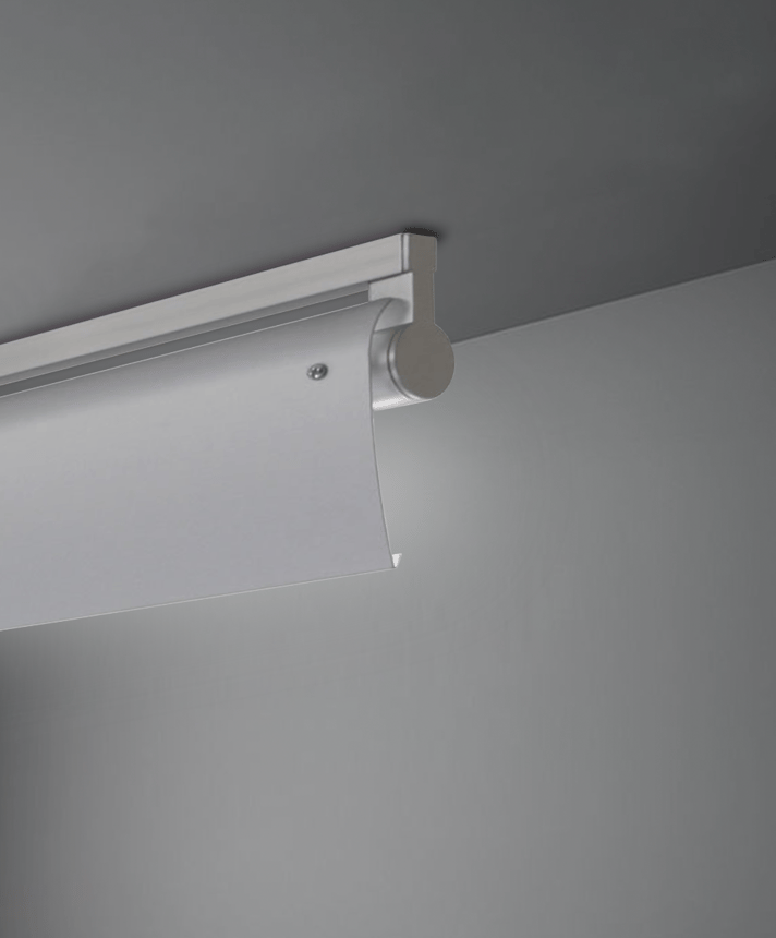 Alcon 12160-WW-S, surface linear ceiling light shown in silver finish, a tubular half-lit trim-less lens, and a curved wall-washing lens cap.