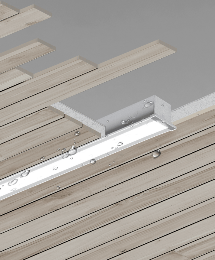 The 12100-24-R wet-location recessed linear LED light shown with a silver finish and a flush lens in a wood ceiling