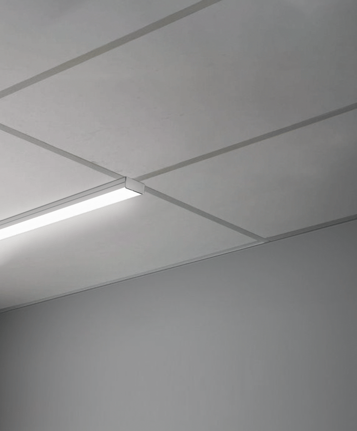 Alcon 14030-10-S, T-bar attaching surface linear ceiling light shown in silver and with a flush lens.