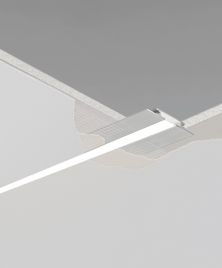 12100-10-R-LR recessed low-rise linear ceiling light by Alcon Lighting, shown in silver finish and with a flush trimless lens
