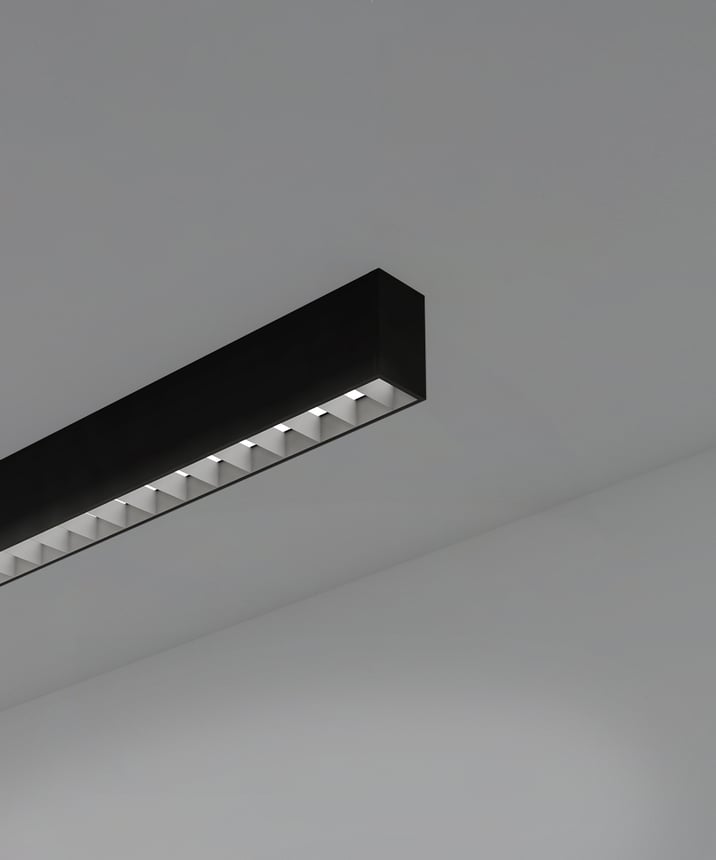 12100-12-S-L linear LED ceiling light shown with black finish and louver lens