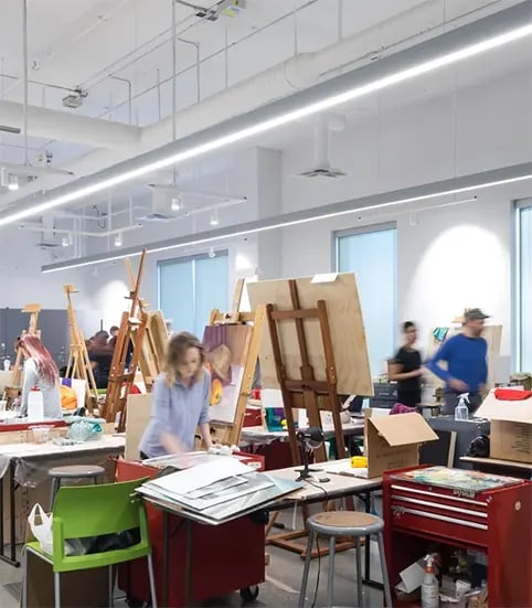 Energy-efficient LED pendant lights and cylinder downlights afford students excellent color representation in a college art classroom.
 