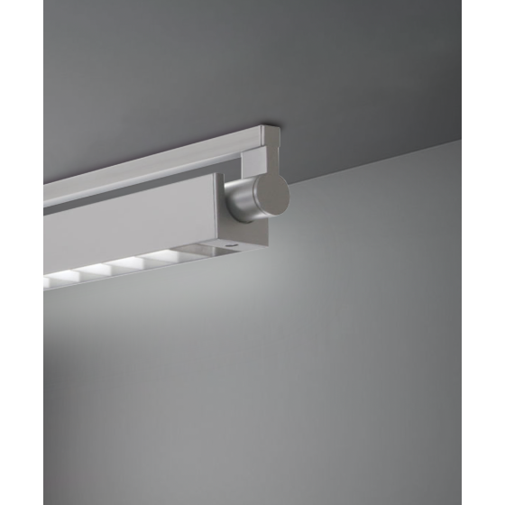Alcon 12160-LDI-S, surface linear ceiling light shown in silver finish, a tubular half-lit trim-less lens, and a square louvered lens cap.