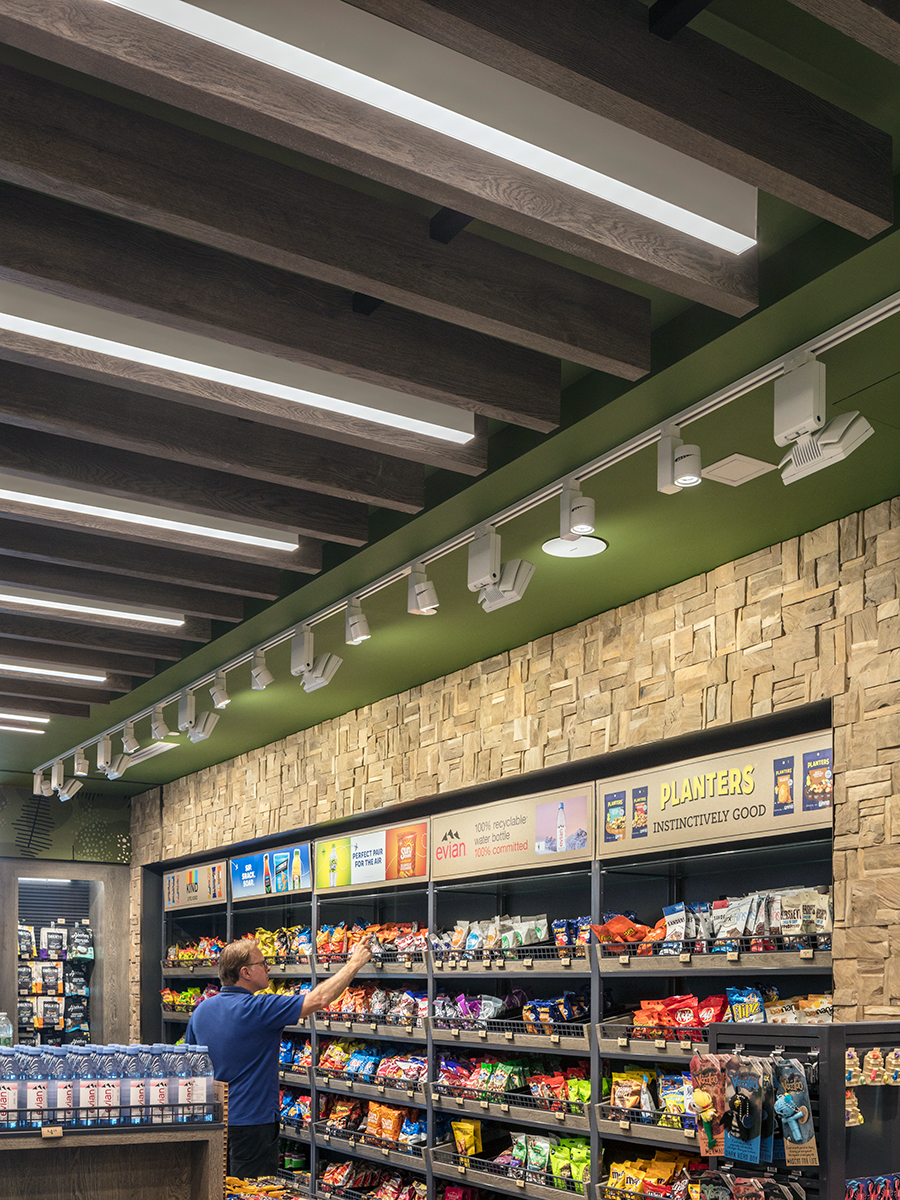 JGA architects fit linear LED lights between wood ceiling planks to conceal the fixtures within the architectural feature.